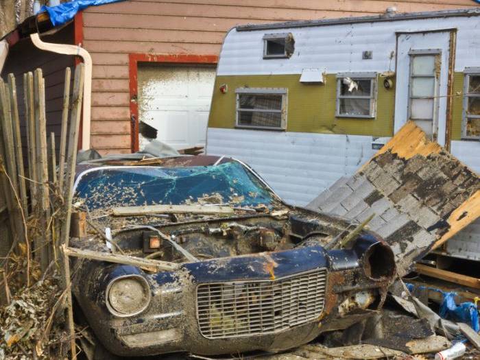 storm-wrecked house and car awaiting an insurance claims adjuster in Atlanta